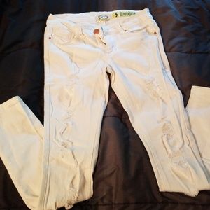 Distressed white skinny jeans